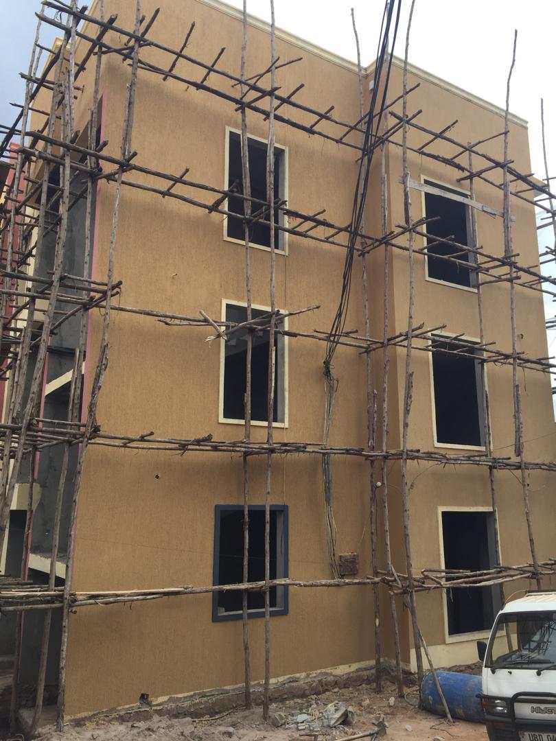 Three-storey building exterior fully scaffolded during render and paint preparation