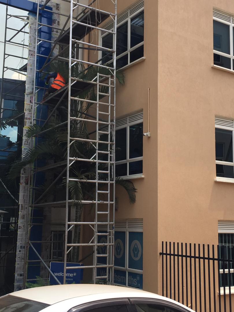 Close view of scaffold access at a glass and render office facade repaint