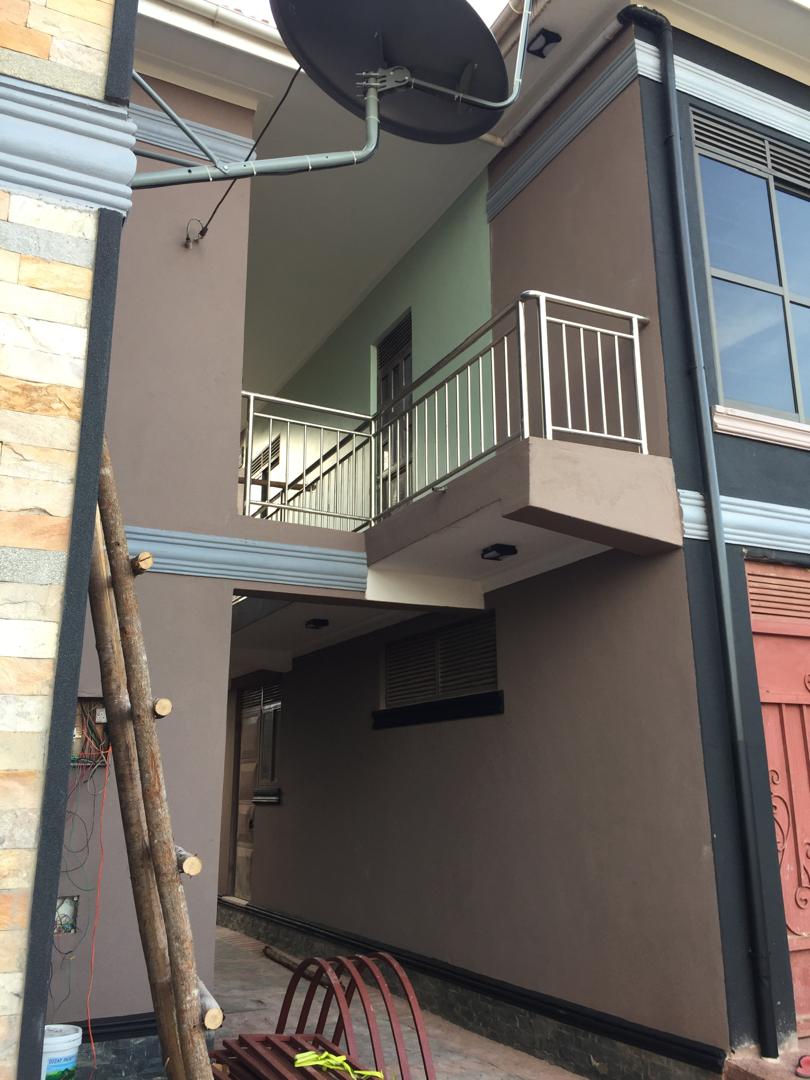Upper floor balcony of a taupe and mauve residential exterior repaint