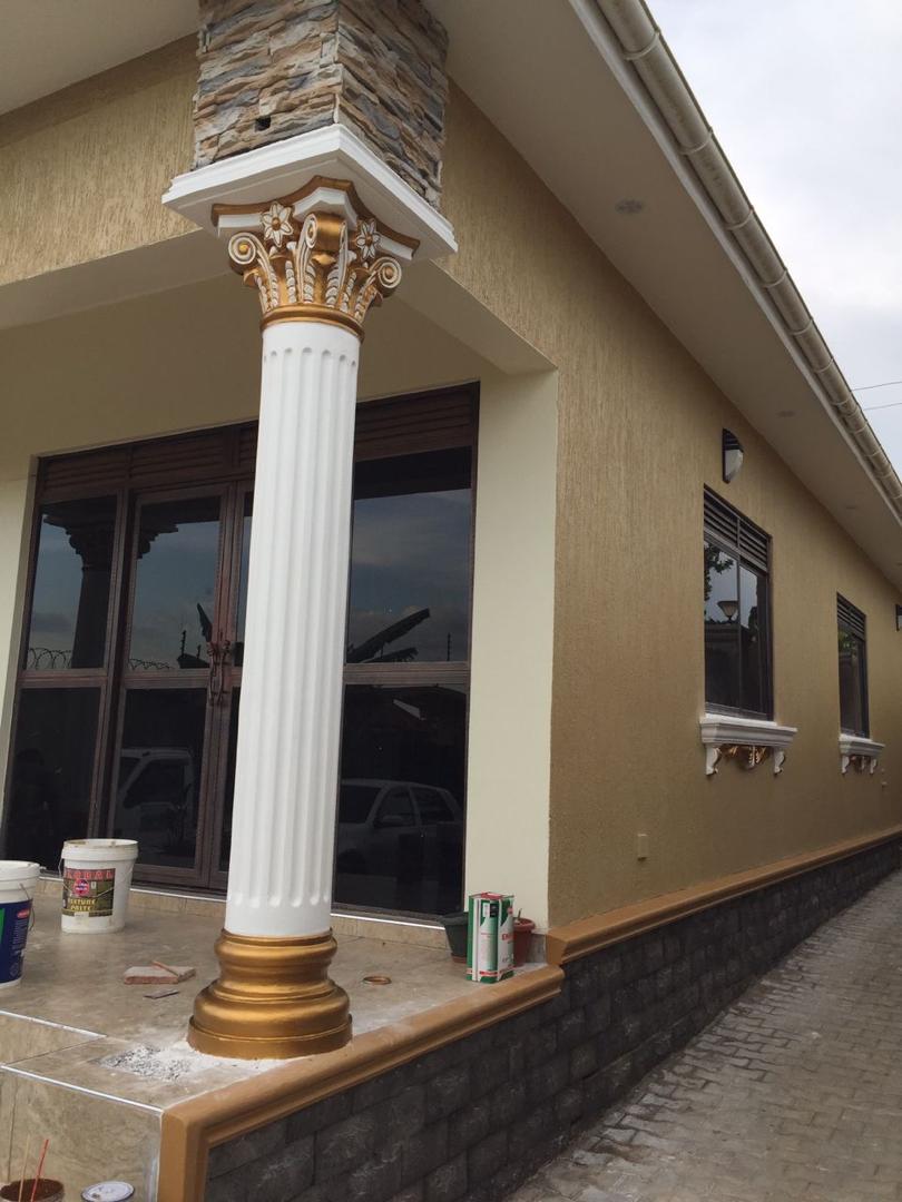 Hand-painted white and gold Corinthian-style porch column on a residential entrance